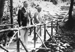 Herbert and Lou Henry Hoover on foot bridge at Rapidan Camp.