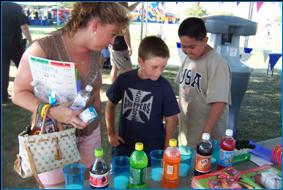 Image of woman and two boys participating in a community event