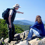 A park ranger points out view points from rocky overlook.