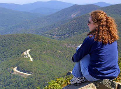 A visitor sits high above Skyline Drive and takes in a breathtaking view.l