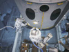 Astronauts working with a Hubble model in a neutral buoyancy tank