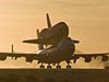 A NASA 747 Shuttle Carrier Aircraft departs with space shuttle Atlantis securely on top for its return to Kennedy Space Center, Fla.