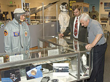 Center Director Kevin Petersen, right, gets a tour of the Gift Shop's new Space Race exhibit from Dryden historian/archivist Peter Merlin.
