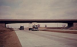 Overhead highway structures can present potential safety hazards, especially for trucks. Medians width, piers, and the height of the structure all play an important role in highway safety.