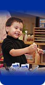 Photo of a boy holding a kitchen utensil