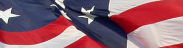 A closeup of stars and stripes on the large flag.