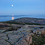 The full moon rises over Cadillac Mountain and Frenchman Bay.