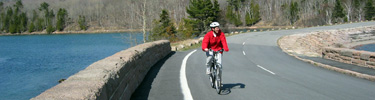 Visitor biking on Otter Creek Causeway along Park Loop Road