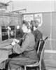 Two Chicago Daily News telephone operators sitting at a switchboard