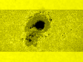 Here is a view of the flare in the optical band, a brighter 'thread' near the lower edge of the upper spot and a bright knot near the center of the lower spot.