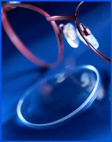 (Photograph of eyeglasses and a lens)