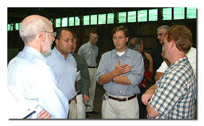 Dr. Robert Pepper (Chief of Policy Development in the Office of Strategic Planning & Policy Analysis), Chairman Powell, Commissioner Martin, and Marty Dougherty discuss Roadstar's network inside the barn at the company's transmitter site.