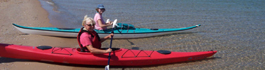 Kayakers launching from the beach at Glen Haven