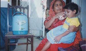 Photo: A Pakistani mother uses PuR treated water in her home. An estimated 250,000 child deaths occur each year in Pakistan due to water-borne disease. Water treated with PuR and stored in a safe container can reduce incidence of diarrhea and other water-borne diseases by up to 50%.