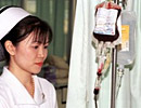 Nurse supervising a blood transfusion