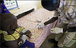 A nurse taking a diagnostic test for malaria in a child in Chad.