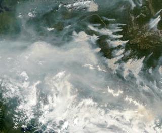 Originally viewing the smoke from a fire in eastern Alaska, we pull back to get a better view of the microscopic, airborne dust and smoke particles that drift away from the fire to other areas of Canada and the United States.  The data shown was collected from June 29, 2004 through July
19, 2004.
