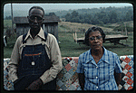 Sabe and Donna Choate standing in front of quilt draped on fence