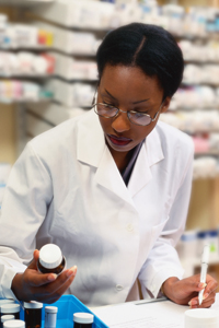 Picture of a female doctor looking at perscription bottles