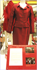 Image of a letter from Mrs. Laura Bush along with her Oscar de la Renta red suit