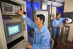 Howard Zhang and chemical engineer David Geveke operate lab equipment used for testing pulsed electric field and radio-frequency electric field treatments. Link to photo information