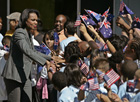 U.S. Secretary of State Condoleezza Rice shakes hands with students holding American and Australian flags at the Peninsula Boys and Girls Club. [© AP Photo]