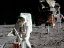 astronaut on the moon setting up instruments