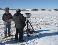 Image of two scientists measuring ammonia emissions during the winter.