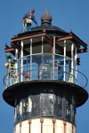 Workers atop the Cape Canaveral Lighthouse lamp room.