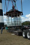 Workers at the Cape Canaveral Lighthouse load the lamp room on a truck.