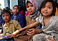 An Indonesian family waits for food and humanitarian relief at Sultan Iskandar Muda Air Force Base in Banda Aceh, Sumatra, Indonesia, Jan. 5, 2005. U.S. Navy photo by Petty Officer 3rd Class Jacob J. Kirk