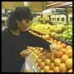 Shopper selecting fruit at the market.