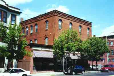 photo: a downtown street with a red brick building in the background