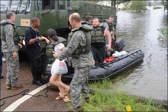 Members of the Mississippi Army National Guard's 20th Special Forces Group launch rubber boats fitted with outboard motors to rescue residents of the flooded Jordan River Shores subdivision in Kiln, Miss., Sept. 1, 2008. U.S. Army photo by 2nd Lt. Steven Stubbs