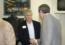 Secy Gutierrez shakes hands with participant