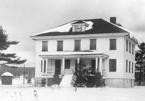 This black and white photo depicts the Munising Coast Guard station in 1968.