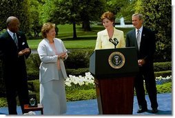 Laura Bush introduces the President George W. Bush during a ceremony honoring National Teacher of the Year Betsy Rogers, left, as Secretary of Education Rod Paige looks on at the White House April 30, 2003.  White House photo by Susan Sterner