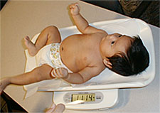 Photo of Infant being weighed