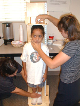 Photo of Child being measured for height