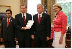 President George W. Bush receives the Report to the President on Issues Raised by the Virginia Tech Tragedy in the Oval Office Wednesday, June 13, 2007, presented to President Bush by Attorney General Alberto Gonzales; U.S. Secretary of Health and Human Services Michael O. Leavitt and U.S. Secretary of Education Margaret Spellings. The report was compiled by the departments of Justice, Health and Human Services and Education in response to the tragic shooting rampage at Virginia Tech April 16, 2007 in Blacksburg, Va.  White House photo by Eric Draper