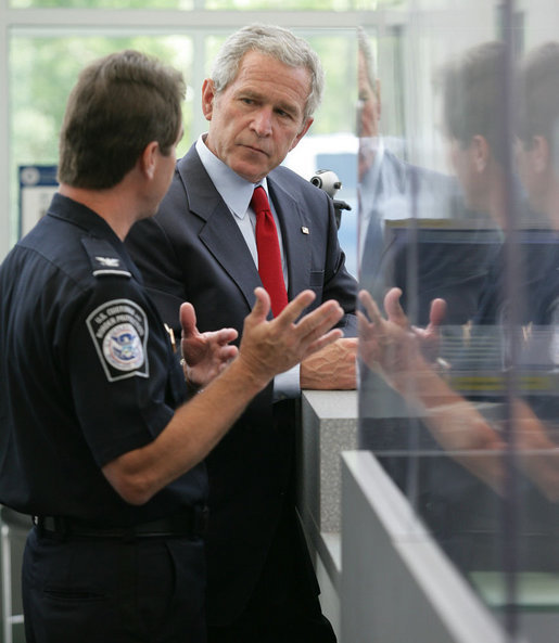 President George W. Bush listens to Ty Bowers, Assistant Director of U.S. Customs and Border Protection, as he demonstrate how people are screened at primary and secondary locations Tuesday, May 29, 2007, during a tour of the Federal Law Enforcement Training Center in Glynco, Ga. White House photo by Eric Draper