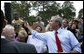 President George W. Bush reaches up to shake the hand of a youngster Tuesday, May 29, 2007, after delivering remarks on comprehensive immigration reform during a visit to the Federal Law Enforcement Training Center in Glynco, Ga. White House photo by Eric Draper