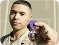 Soldier holding up purple heart