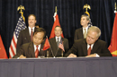 Participants sign during the US/Vietnam Signing Ceremony