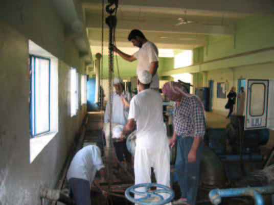 photo: Workmen repair pumps at the Unified Besrah Water Treatment Plant