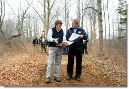 President George W. Bush looks over maps of the Wells National Estuarine Research Reserve with Manager Paul Dest in Wells, Maine, Thursday, April 22, 2004.  White House photo by Eric Draper