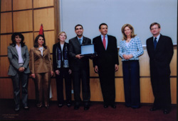 Executive Director Khaled Al Gazawi holds a plaque announcing JMCC's graduation from the Wholesale Funding Facility.