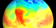 View of the US with red (denoting highest ground levels of ultraviolet radiation) covering the western portion and the equatorial region.  The colors spread from the red into yellows, blues, and greens away from these areas, denoting lower ground levels of ultraviolet radiation.  This data was collected over the year 2000.