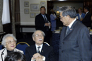 Former Secretary of Commerce Norman Mineta shakes hands with visitors to the unveiling of his official portrait