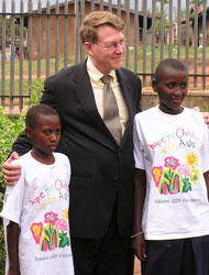Photo of Dr. Kent R. Hill, Acting Assistant Administrator for Global Health, with two children in Uganda.